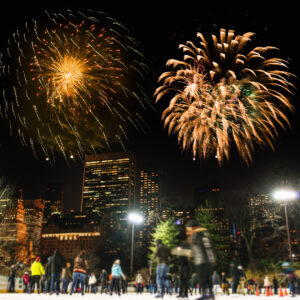 People skating on central park in New York city with fireworks