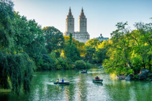 People paddle in boats in Central Park, New York City.