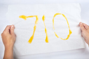 710 cannabis wax day concept, golden dab text in hand.